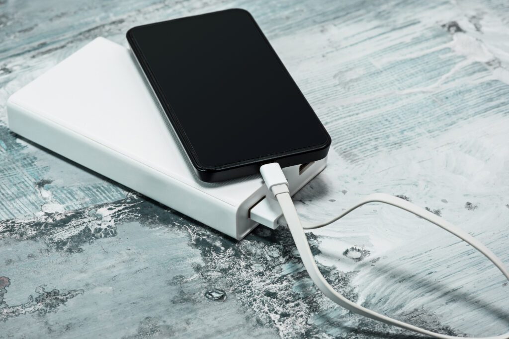 Power bank and mobile phone on gray desk